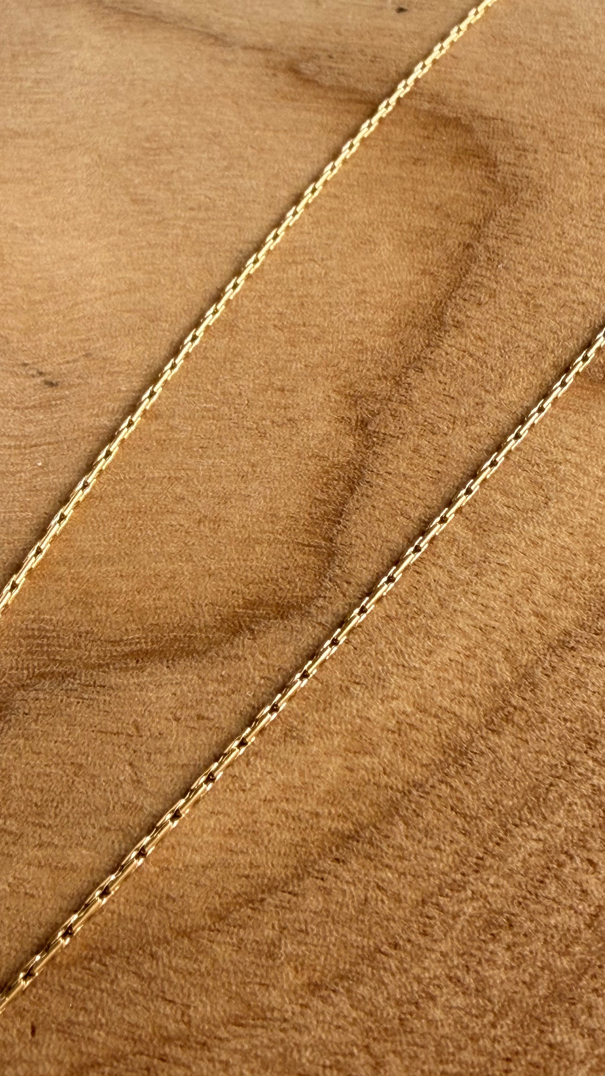 Gold chain on a wooden background