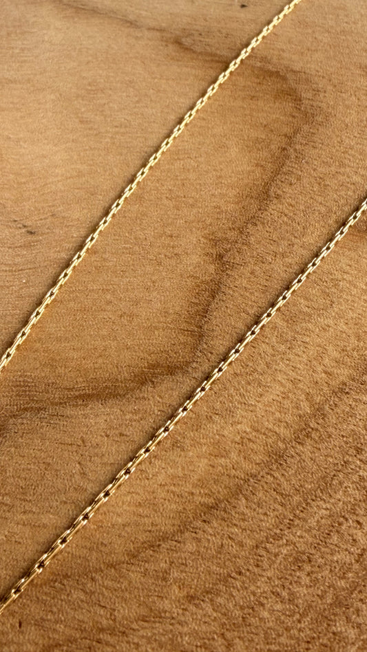 Gold chain on a wooden background