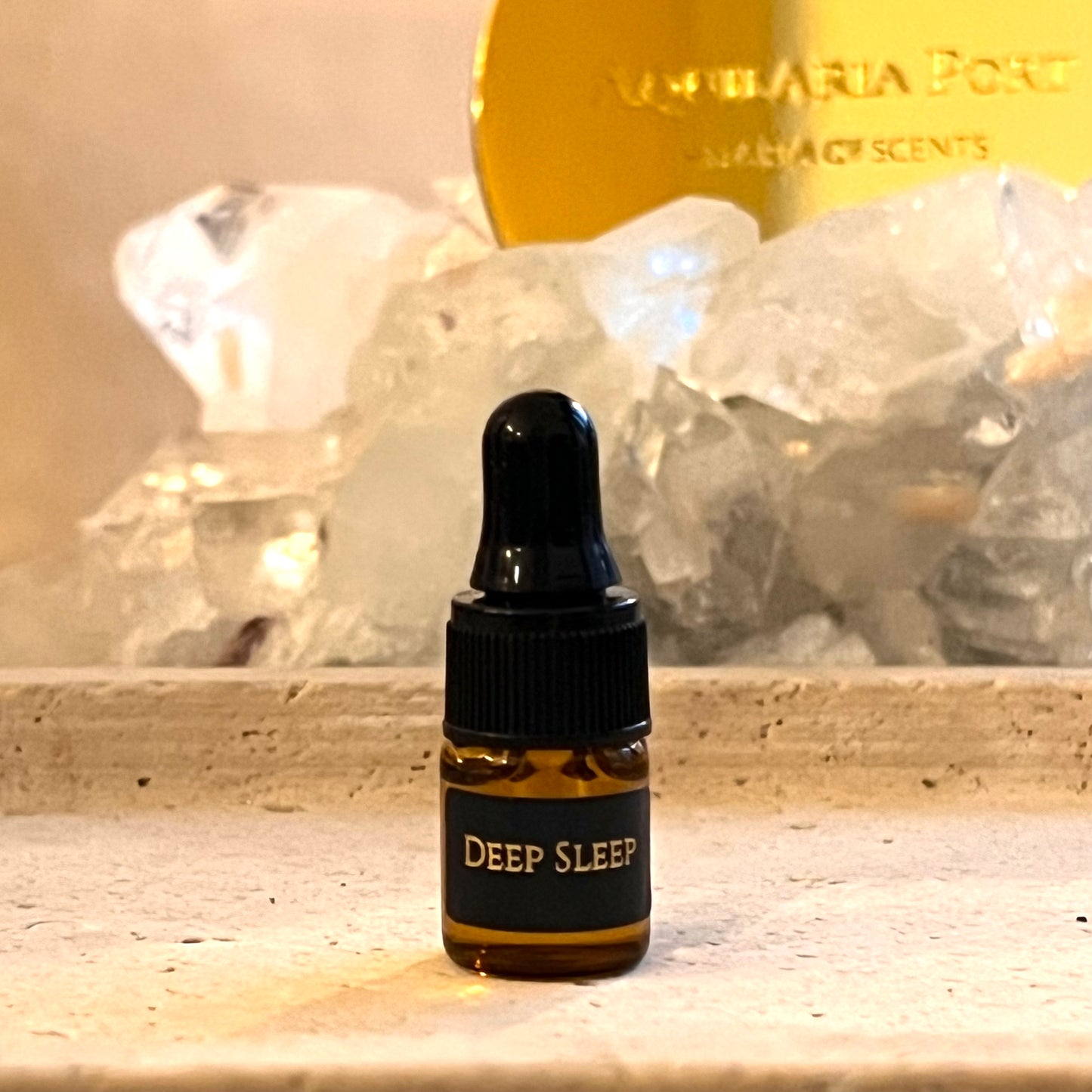 Small bottle labeled 'Deep Sleep' with a decorative background featuring crystals and a gold plaque.