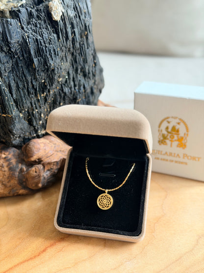 Gold necklace in a jewelry box with a brand logo in the background