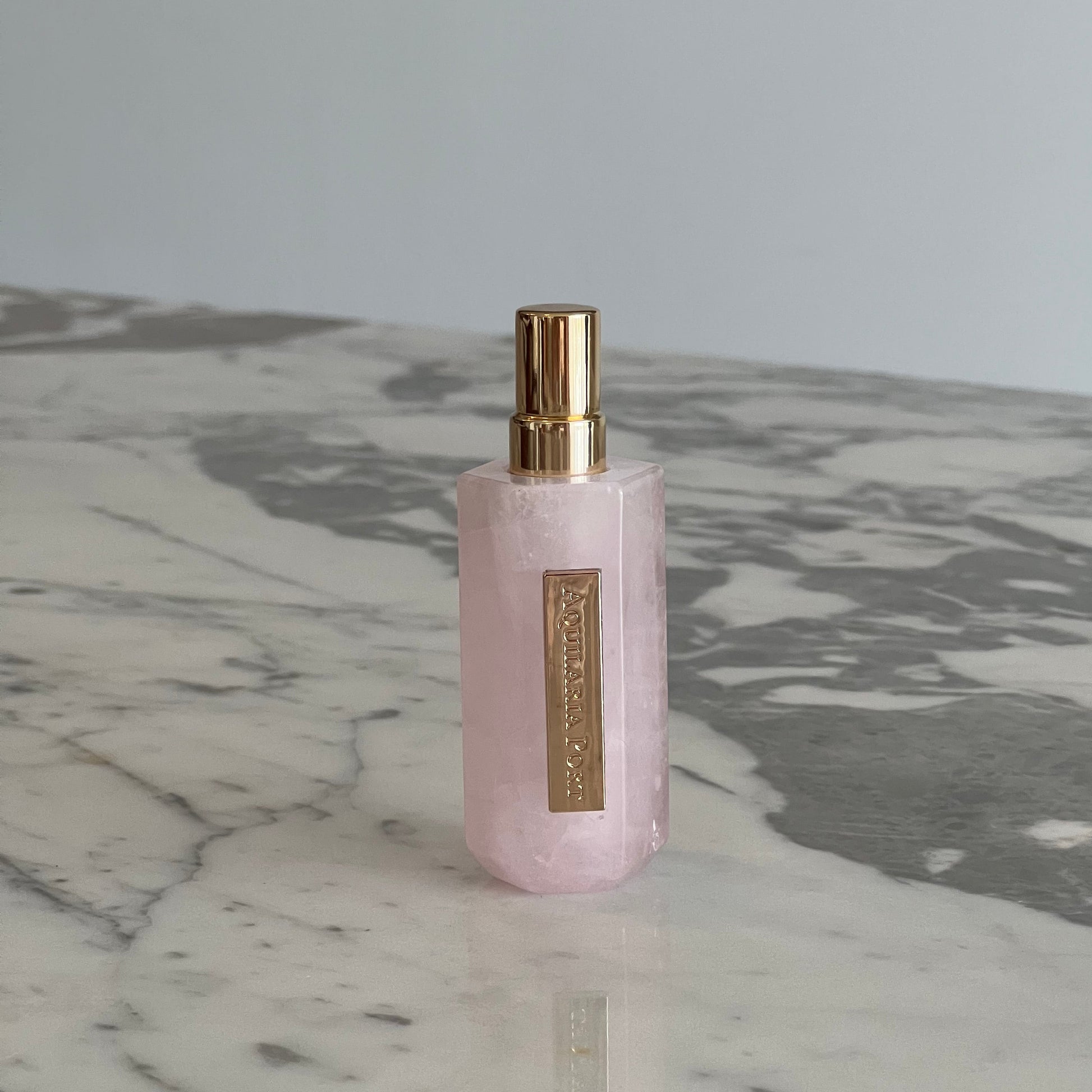 Luxury natural extrait de parfum in a pink quartz atomiser by Aquilaria Port
