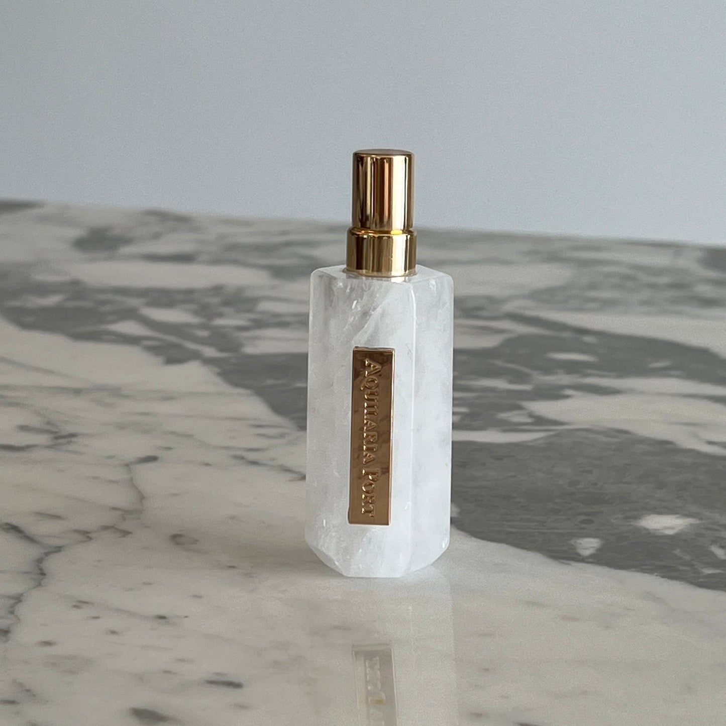 Luxury natural extrait de parfum in a white quartz atomiser by Aquilaria Port