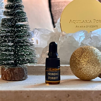 Bottle of 'Nordic Forest' essential oil with decorative items on a surface